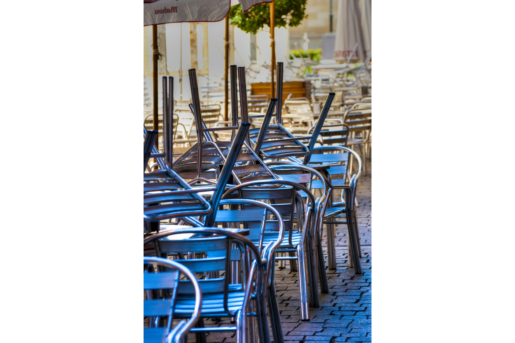 Chairs and tables stack in restaurant outdoor seating area